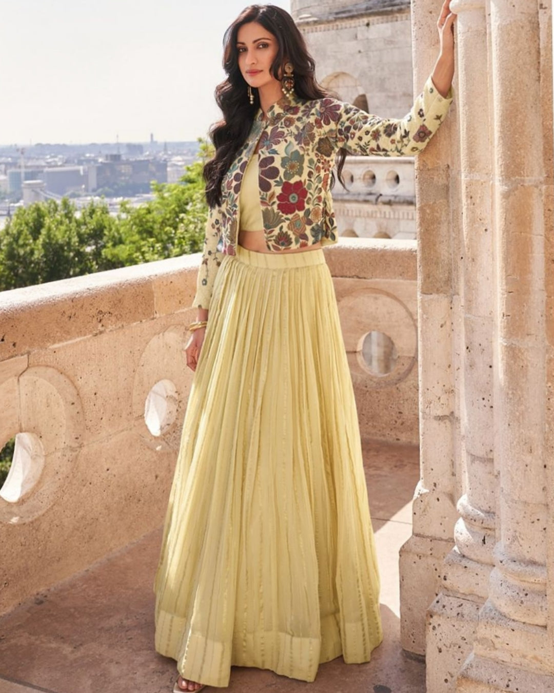 Chinon silk floral embroidered jacket paired with a bright yellow pleated lehenga, perfect for festive occasions and weddings, available at Sakhi Fashions