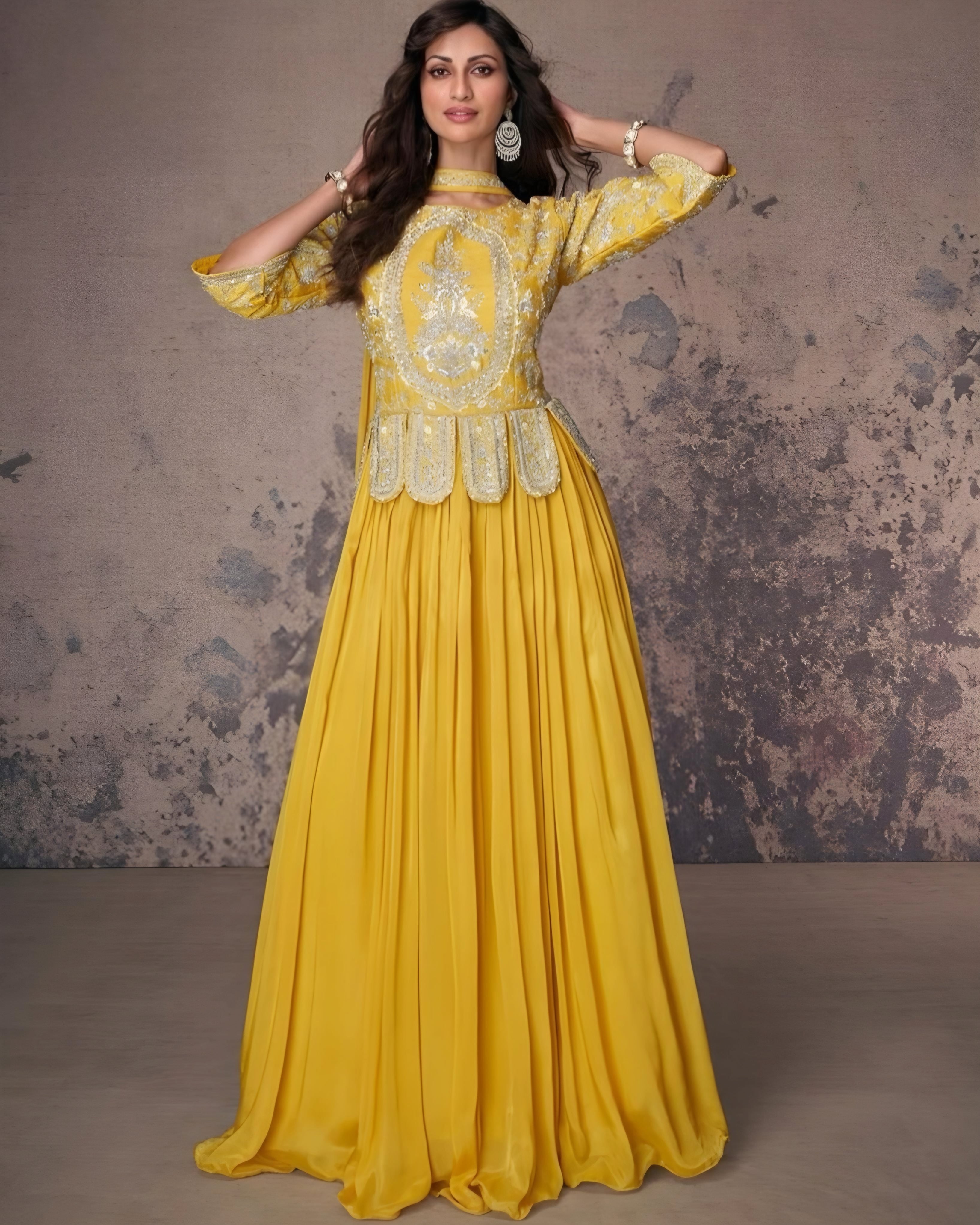 Vibrant yellow peplum top with intricate silver embroidery paired with a flowy skirt, ideal for weddings and festive events, available at Sakhi Fashions