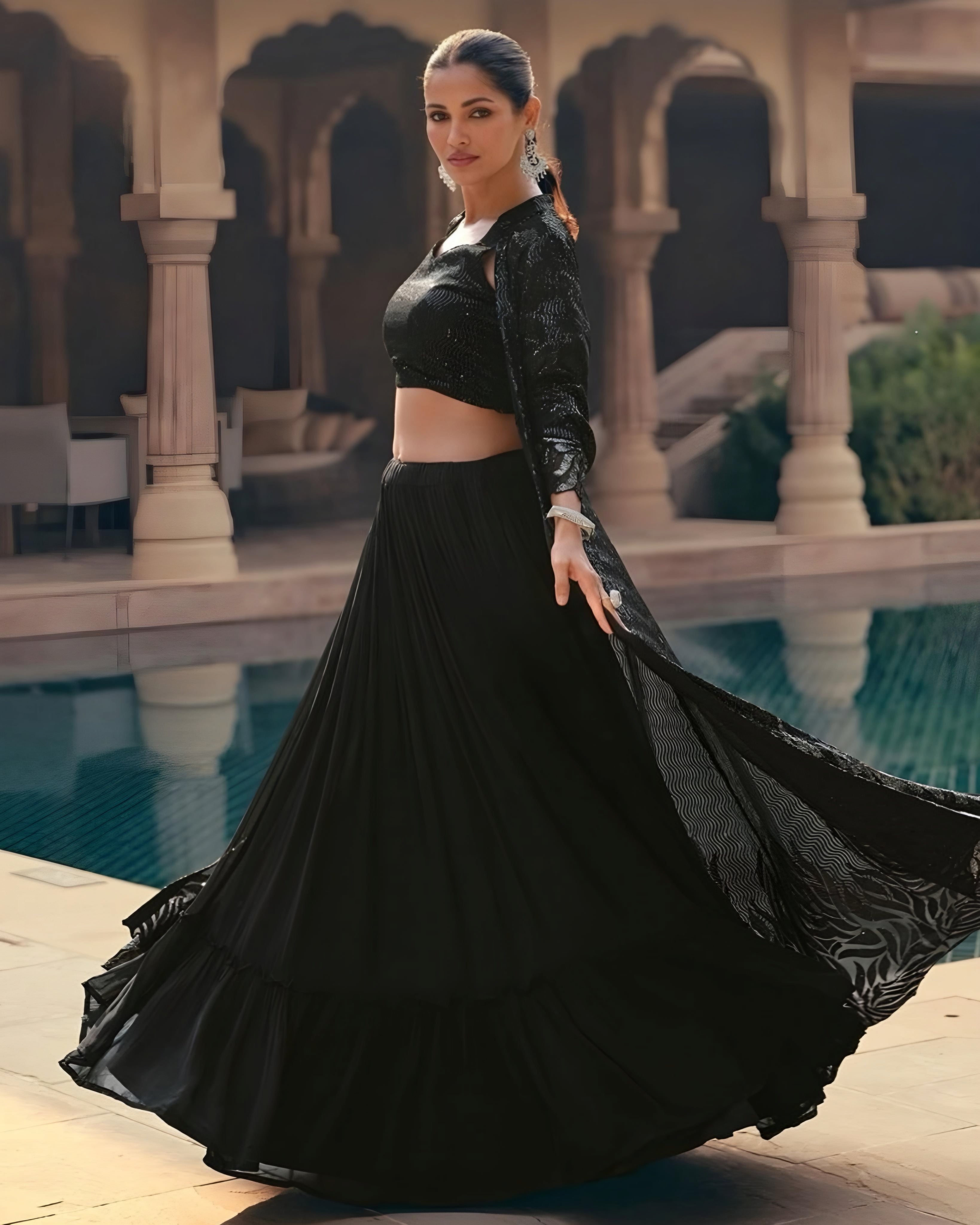 Side view of a chic black sequin lehenga set with a crop top and matching dupatta, showcasing elegant detailing perfect for special occasions.