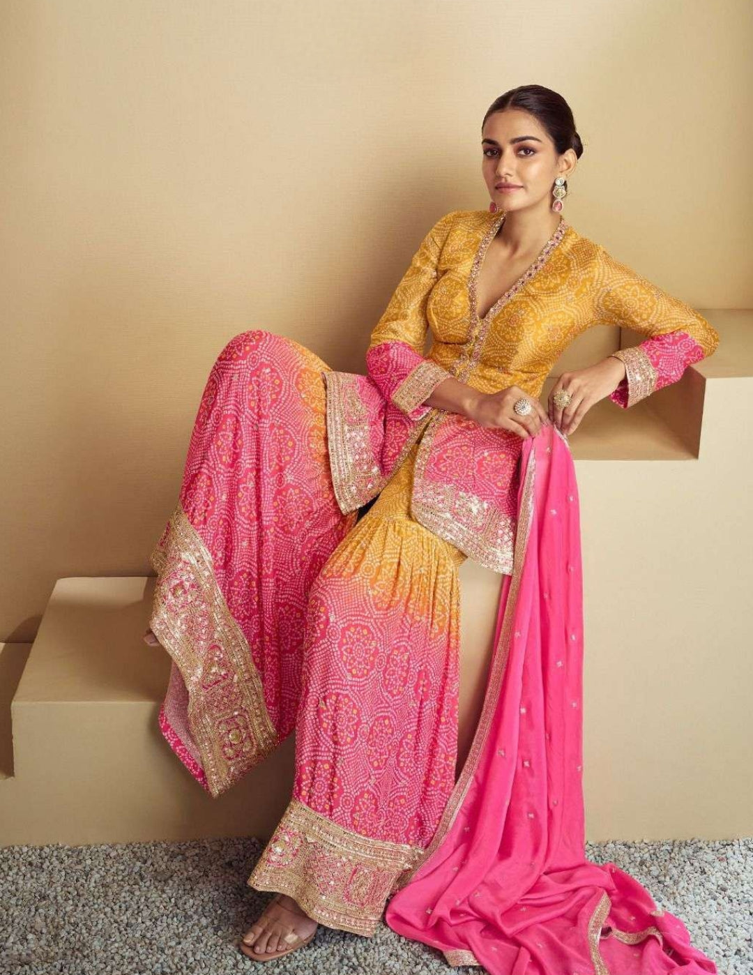 Side view of the yellow and pink Bandhani suit, featuring intricate embroidery on the kameez and wide-legged palazzo pants with ombré detailing.